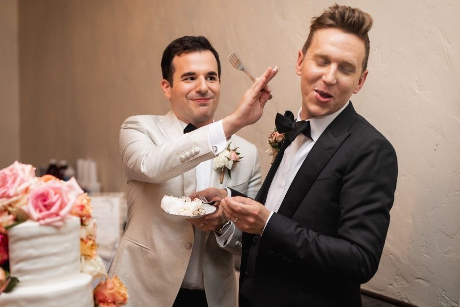 groom and groom with wedding cake
